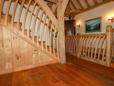 a wooden staircase in a room with wooden floors at Oakenhurst in Fowey