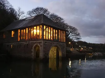 a building on a bridge over a body of water at Oakenhurst in Fowey