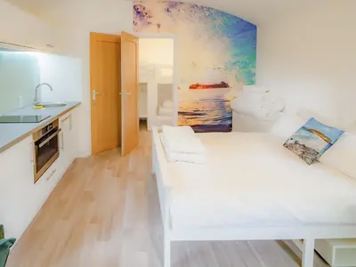 a white room with a white couch and a kitchen at Owl - Uk43447 in Hayle