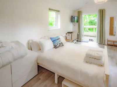 a large white bedroom with a large white bed at Owl - Uk43447 in Hayle