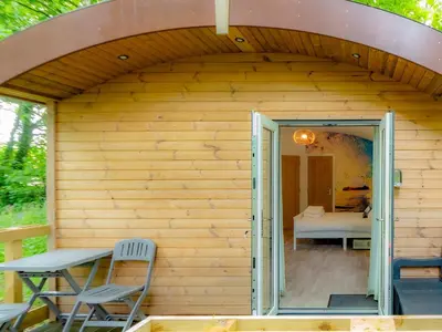 a small house with a patio and a table and chairs at Owl - Uk43447 in Hayle