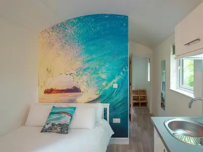 a bedroom with a large painting on the wall at Woodpecker - Uk43451 in Hayle
