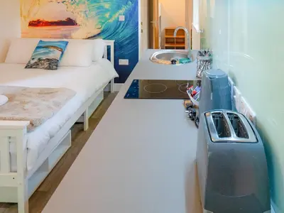 a small room with a bed and a sink at Woodpecker - Uk43451 in Hayle