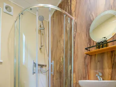 a bathroom with a shower and a sink at Woodpecker - Uk43451 in Hayle