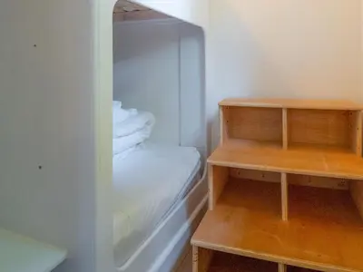 a small closet with wooden shelves and a bed at Woodpecker - Uk43451 in Hayle