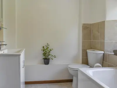 a bathroom with a toilet and a plant in the tub at Moorside - Uk43497 in Lostwithiel