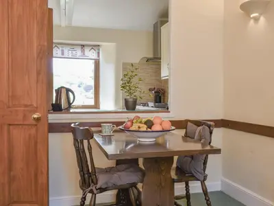 a kitchen with a table with a bowl of fruit on it at Moorside - Uk43497 in Lostwithiel