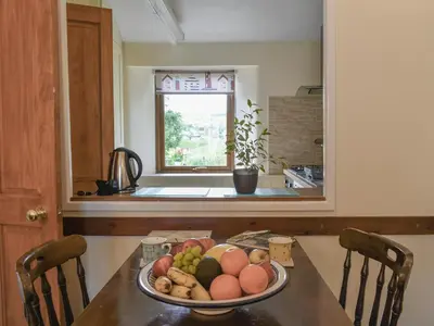 a plate of fruit on a table in a kitchen at Moorside - Uk43497 in Lostwithiel