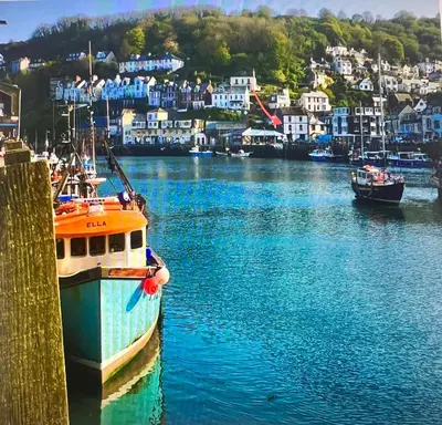 two boats are docked in a body of water at 4 Quay View, Looe in Looe