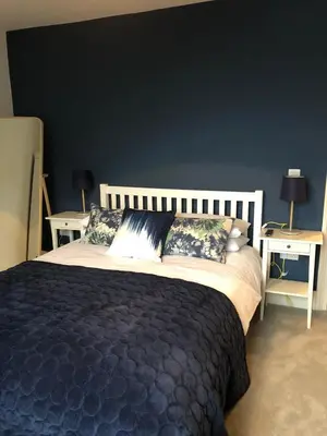 a bedroom with a large bed with two tables at 4 Quay View, Looe in Looe