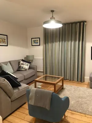 a living room with a couch and a coffee table at 4 Quay View, Looe in Looe
