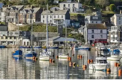 a group of boats docked in a harbor with houses at 4 Quay View, Looe in Looe