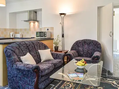a living room with two chairs and a coffee table at Poundhouse - Uk43496 in Lostwithiel