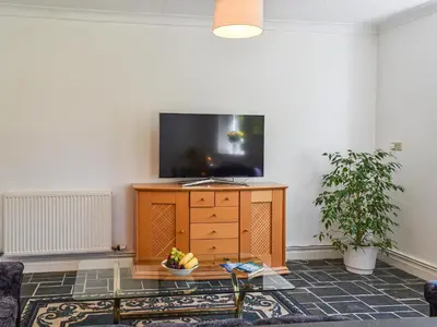 a living room with a tv on top of a dresser at Poundhouse - Uk43496 in Lostwithiel