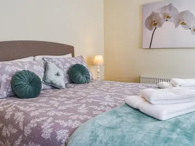 a bedroom with a bed with pillows on it at Poundhouse - Uk43496 in Lostwithiel