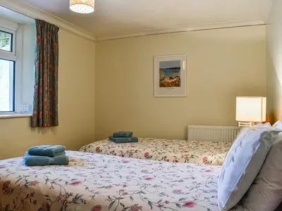 a bedroom with two beds and a window at Poundhouse - Uk43496 in Lostwithiel