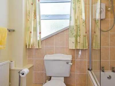 a bathroom with a toilet and a shower at Poundhouse - Uk43496 in Lostwithiel