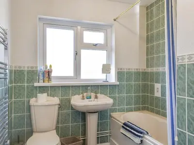 a bathroom with a toilet and a sink and a tub at The Batch in St Merryn