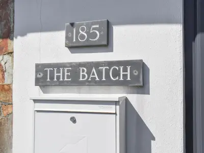 a sign on the side of a building with a door at The Batch in St Merryn