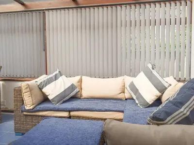 a couch with pillows on it in a room at The Batch in St Merryn