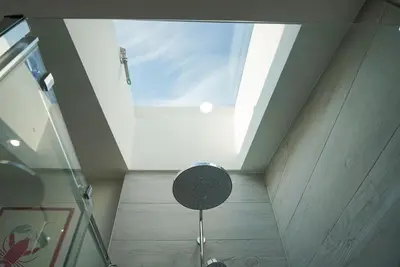 a chair in a room with a skylight at Luxury holiday cottage by the harbour in St Mawes in Saint Mawes