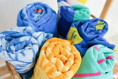 a bunch of towels are arranged in a basket at Luxury holiday cottage by the harbour in St Mawes in Saint Mawes