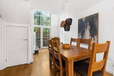 a dining room with a wooden table and chairs at House 5 Ironcroft - Modern Pet-friendly, Walk to beach & village in Porthtowan