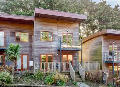 a wooden house with a staircase in front of it at House 5 Ironcroft - Modern Pet-friendly, Walk to beach & village in Porthtowan