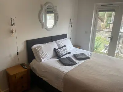 a bedroom with a bed with two pillows on it at House 6 Goldcroft - Walk to Beach & Village, Pet-friendly & hottub in Porthtowan