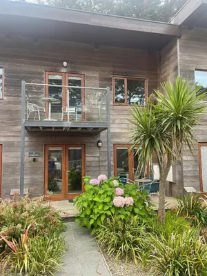 a house with a balcony and a tree at House 6 Goldcroft - Walk to Beach & Village, Pet-friendly & hottub in Porthtowan