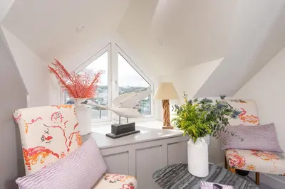 a room with two chairs and a window at Beach Vista, harbourside in St Ives in St Ives