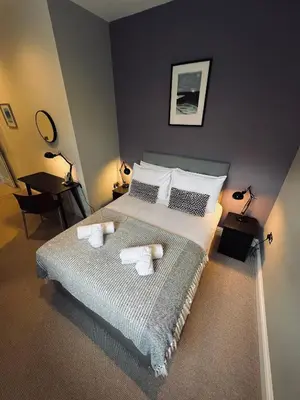 a bedroom with a bed with two towels on it at 8, St Marys , Private Double Ensuite Room - Room Only- Truro in Truro