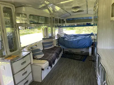 an empty bus with a couch in the back of it at The Quarry Caravan in Falmouth