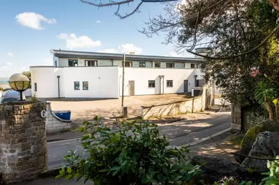 a white building on the side of a road at Apartment 3 at Porthminster Mews in St Ives