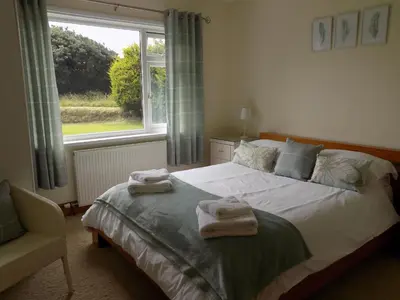 a bedroom with a bed with towels on it at Brookfield in Bude