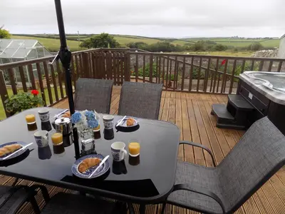 a table with food and drinks on a deck at Brookfield in Bude