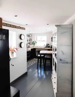 a kitchen with a table and a dining room at The Old Stores, Luxury beach side selfcatered holiday cottage above the beach in Porthleven