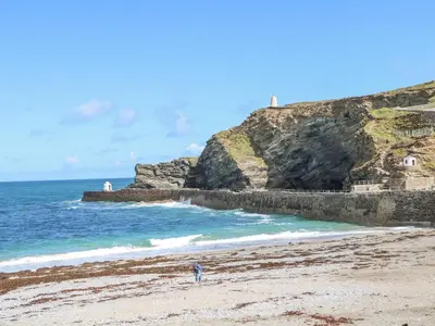 a person standing on a beach next to the ocean at Kensa in Redruth