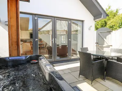 a patio with a water slide and a table at Kensa in Redruth