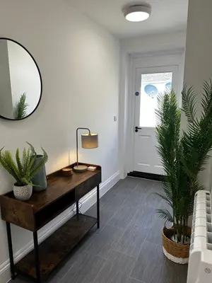 a room with a table with a mirror and two plants at The Lugger Inn in Polruan