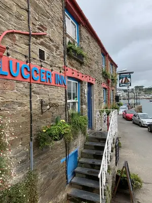 a sign on the side of a building at The Lugger Inn in Polruan