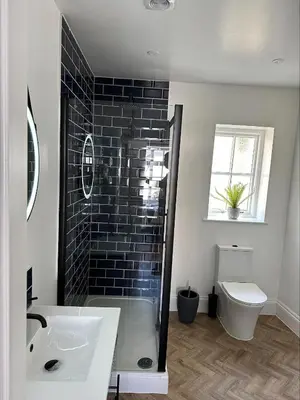 a bathroom with a shower and a sink and a toilet at The Lugger Inn in Polruan