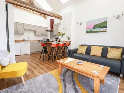 a living room with a couch and a table at Harvenna Cottage in Bude