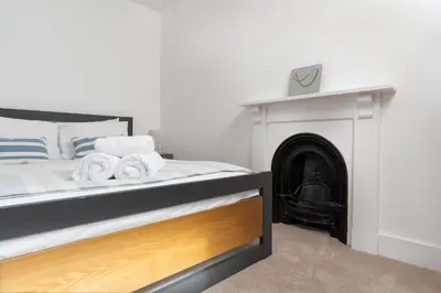 a bedroom with a bed with a fireplace at Marazion Charming Retreat for 6 with Social Garden in Marazion