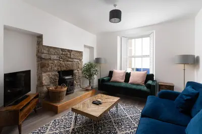 a living room with a couch and a fireplace at Marazion Charming Retreat for 6 with Social Garden in Marazion