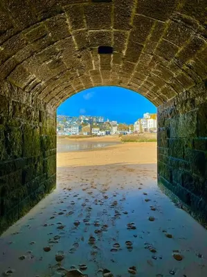 a stone bridge over a body of water at The Little Loft St Ives in St Ives