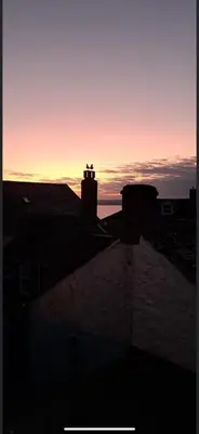 a view of a sunset from the roof of a building at The Little Loft St Ives in St Ives