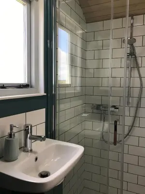 a bathroom with a sink and a shower at Ewe With A View Sea View Shepherds Huts in Breage