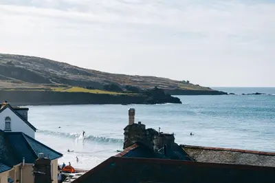 a view of a beach with people surfing in the water at Beachside Guesthouse in St Ives