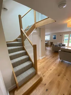 a spiral staircase in a living room with a couch at Luxury retreat with hot tub & wood burner - Mylor in Falmouth